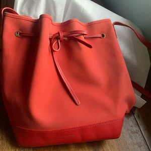 Mansur Gavriel canvas bucket bag in red with leather tie detail and strap